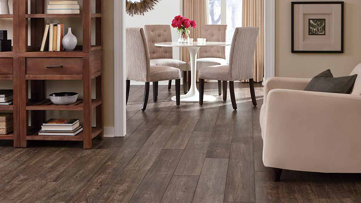 dark stained laminate flooring in an elegant living and dining area